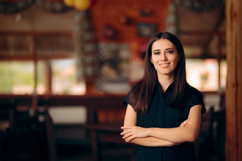 Manager,Standing,In,A,Restaurant,Welcoming,Customers.,Confident,Self employed,Female