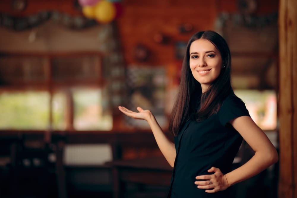 Manager,Standing,In,A,Restaurant,Welcoming,Customers.,Confident,Self employed,Female