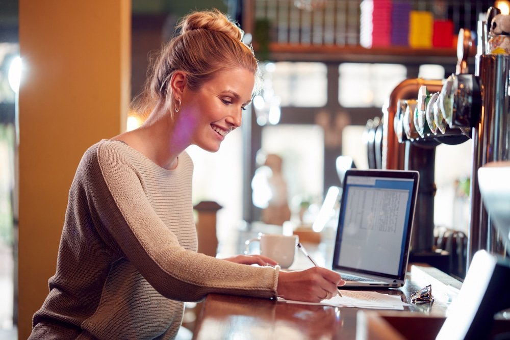 Female,Owner,Or,Manager,Of,Bar,Working,On,Laptop,On
