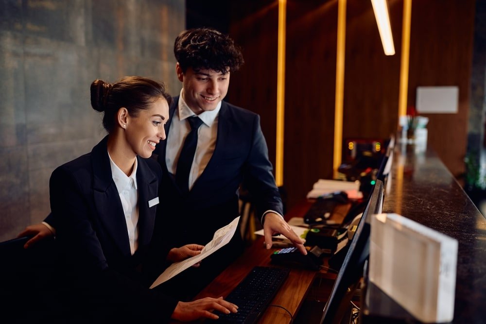 Happy,Hotel,Managers,Through,Reservation,List,On,Desktop,Pc,At
