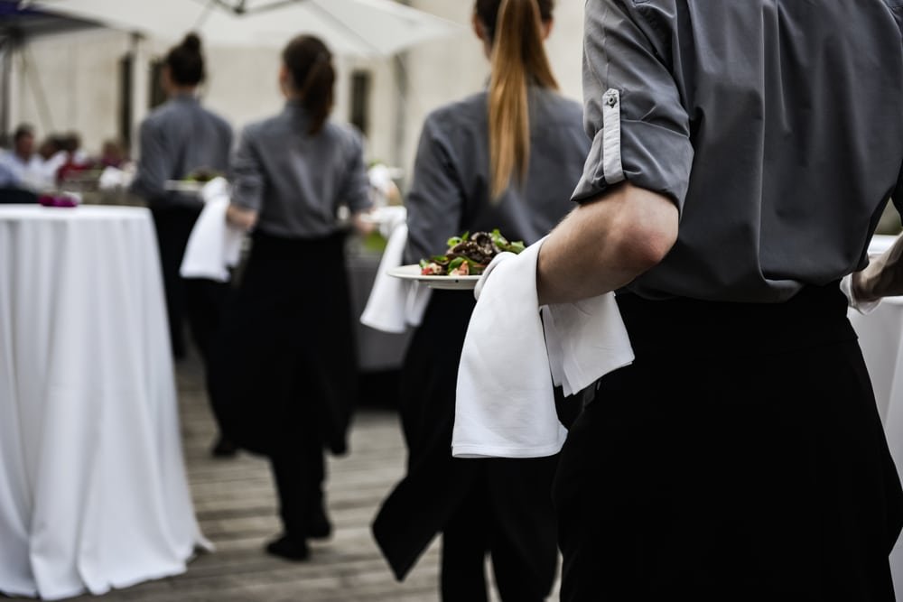 Waiter,Carrying,Plates,With,Meat,Dish,On,Some,Festive,Event
