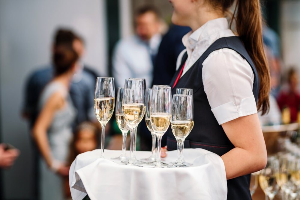Waitress,Holding,Champage,Glasses.,Catering,For,A,Special,Event/party.