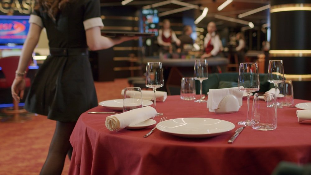 Waiter,Serving,Food,For,People,In,Restaurant.,Close,Up,Of