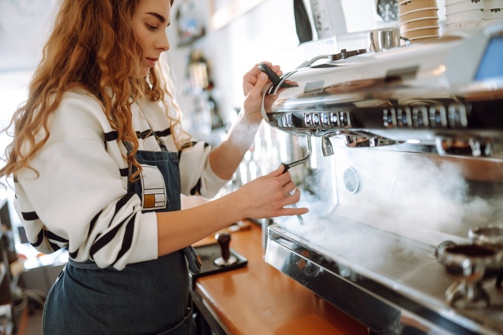 Female,Barista,Making,Coffee,In,Coffee,Shop,Counter.,Takeaway,Food.