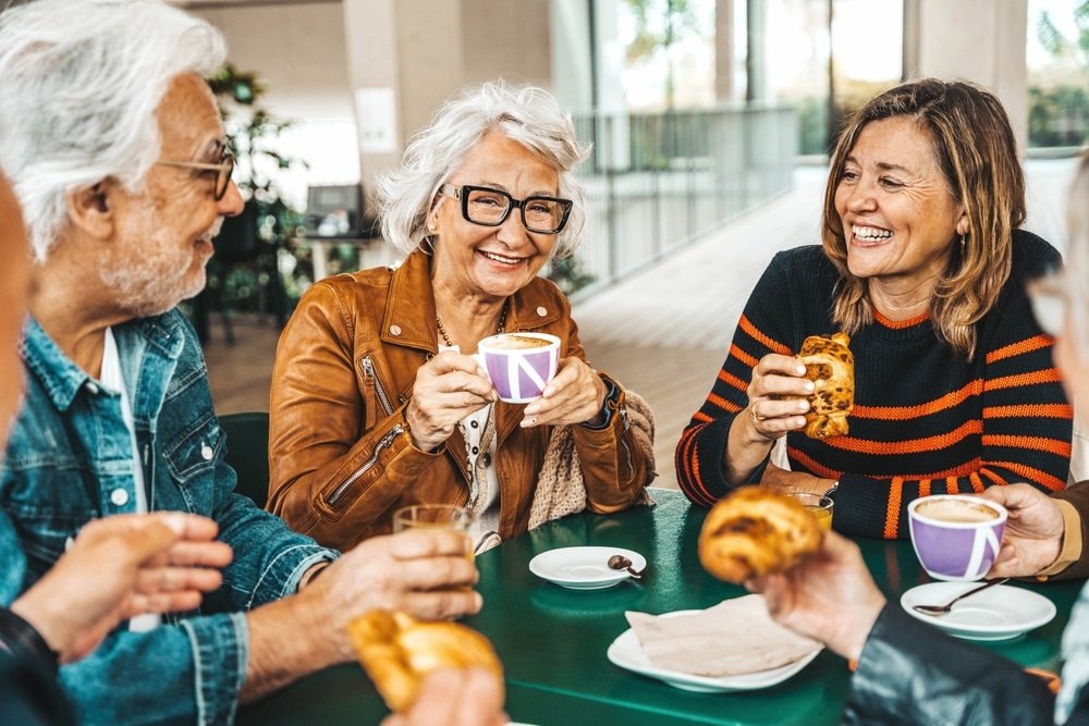 Happy,Senior,People,Having,Breakfast,Sitting,At,Cafe,Bar,
