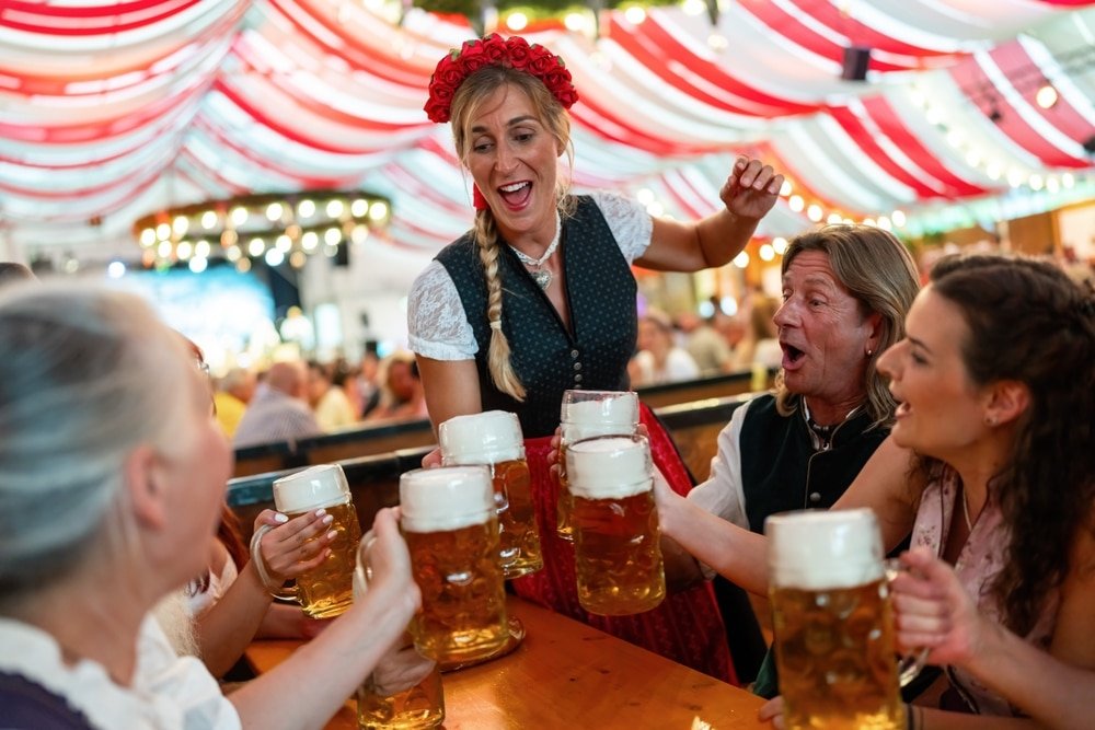 Group,Of,People,In,Traditional,Bavarian,Attire,Toasting,With,Beer